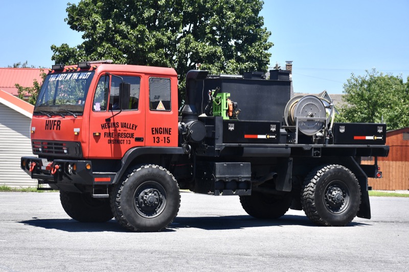 Engine 13-15, a red former military Stewart and Stevenson truck with a black pump body and hose reel, lettered Hegins Valley Fire-Rescue. Photo: Mike and Andrew Sanders.